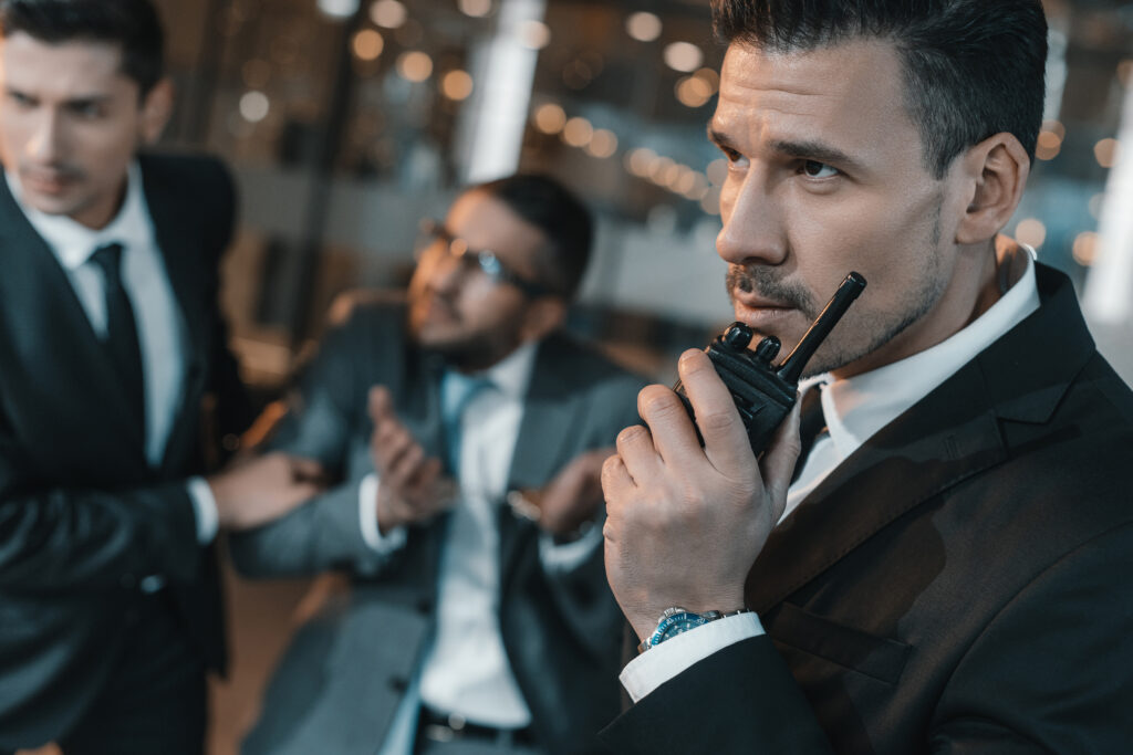 Two men in suits and ties are talking on a radio.