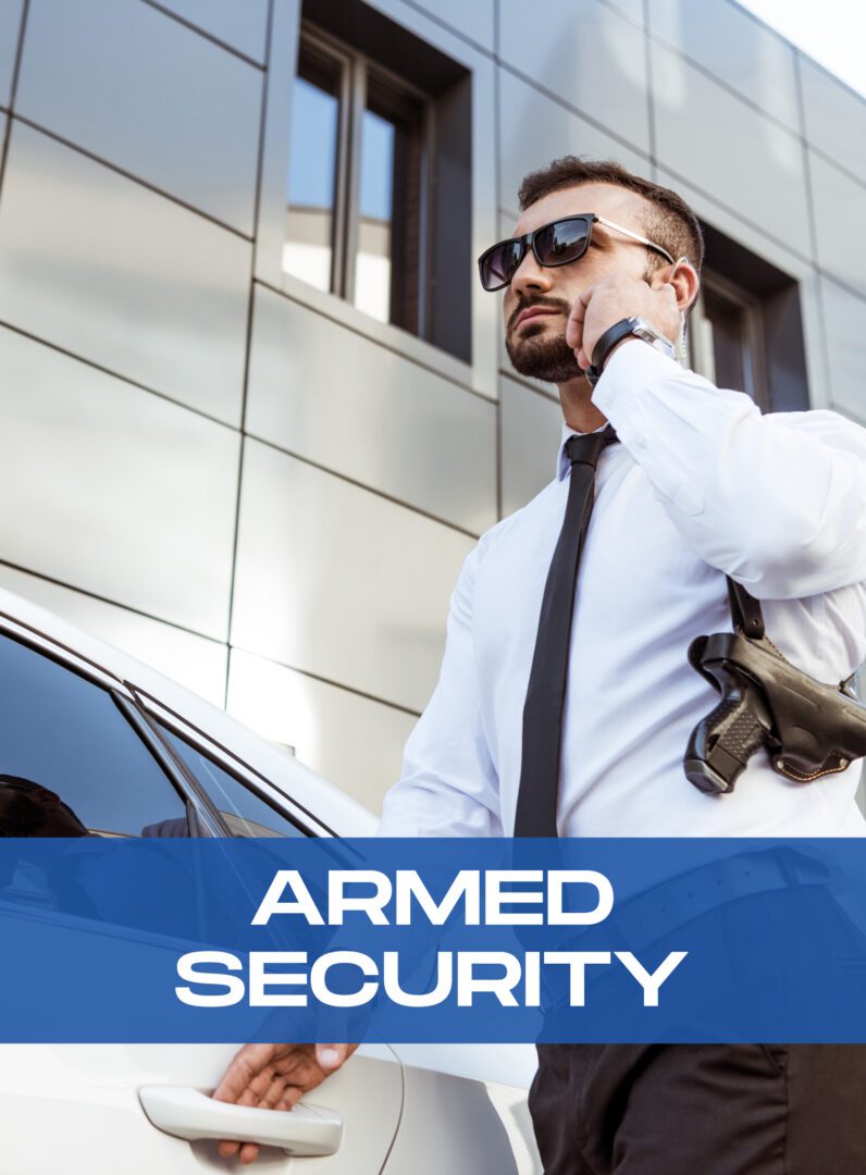 Armed security guard standing next to a car.